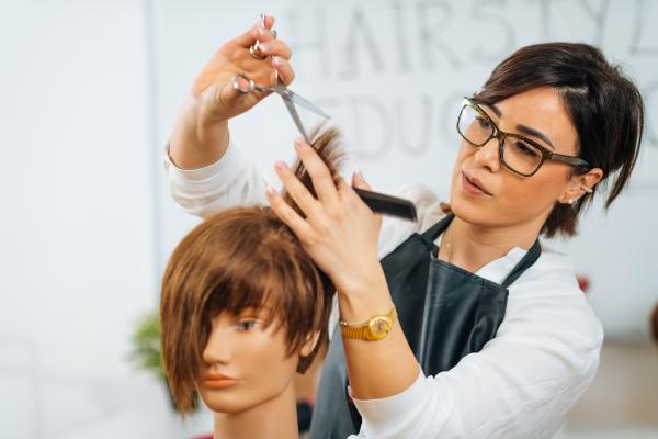 girl cutting mannequin hair