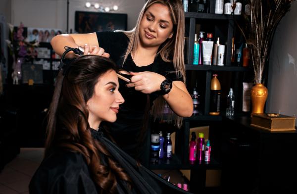 girl performing hair service on a client